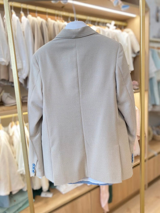 Beige suit with blue tie